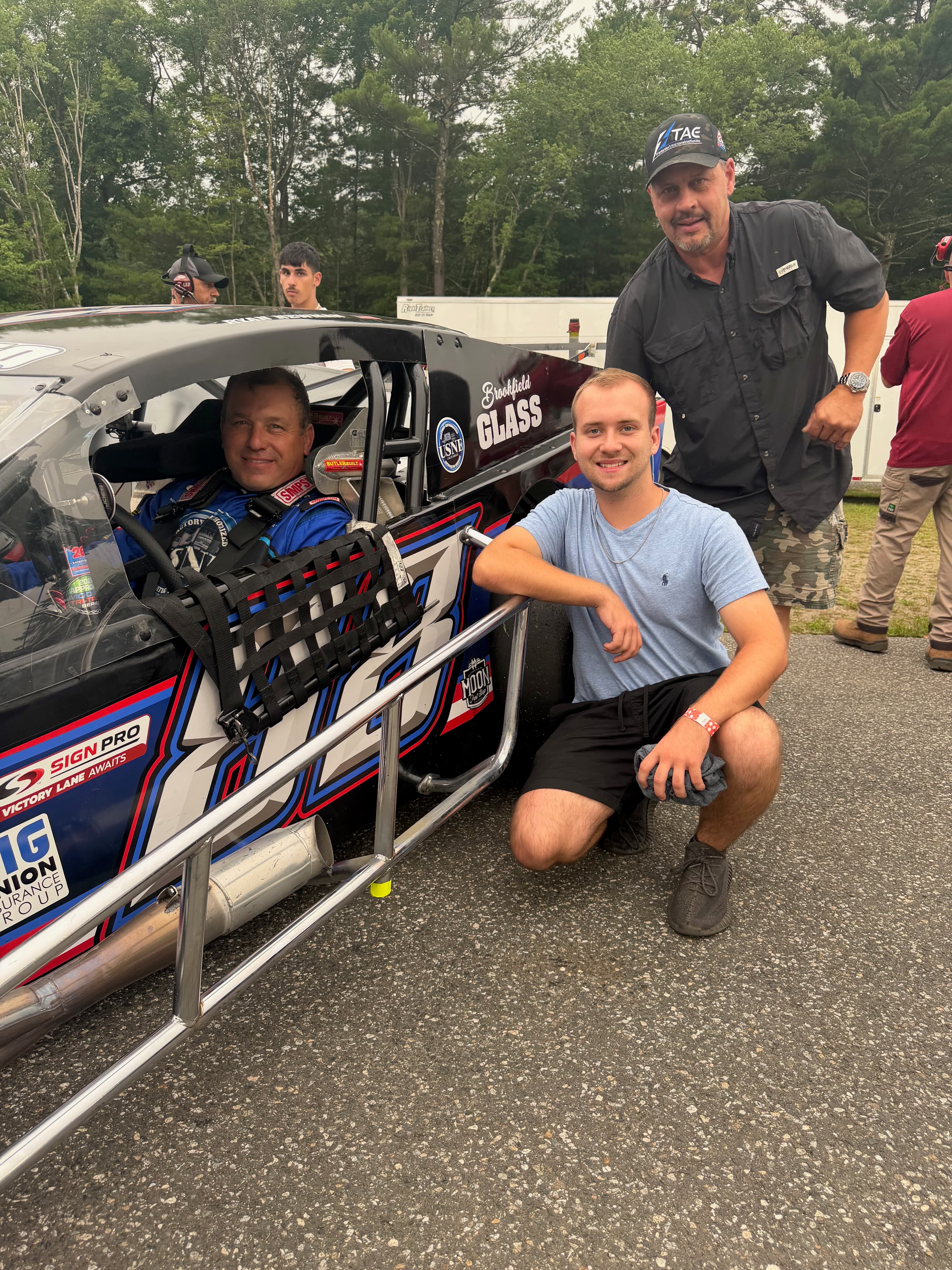 Team at pit lane with Tri-Area Electric sponsored race car